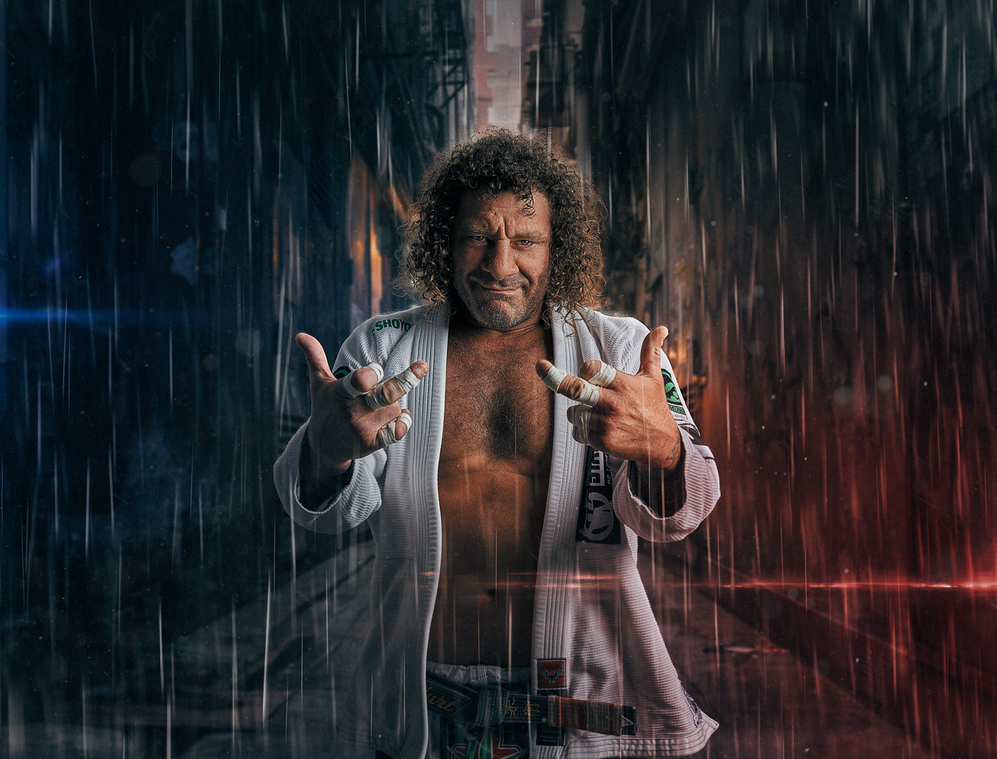 Kurt Osiander standing in the rain giving double rude fingers by Brent Young Photography